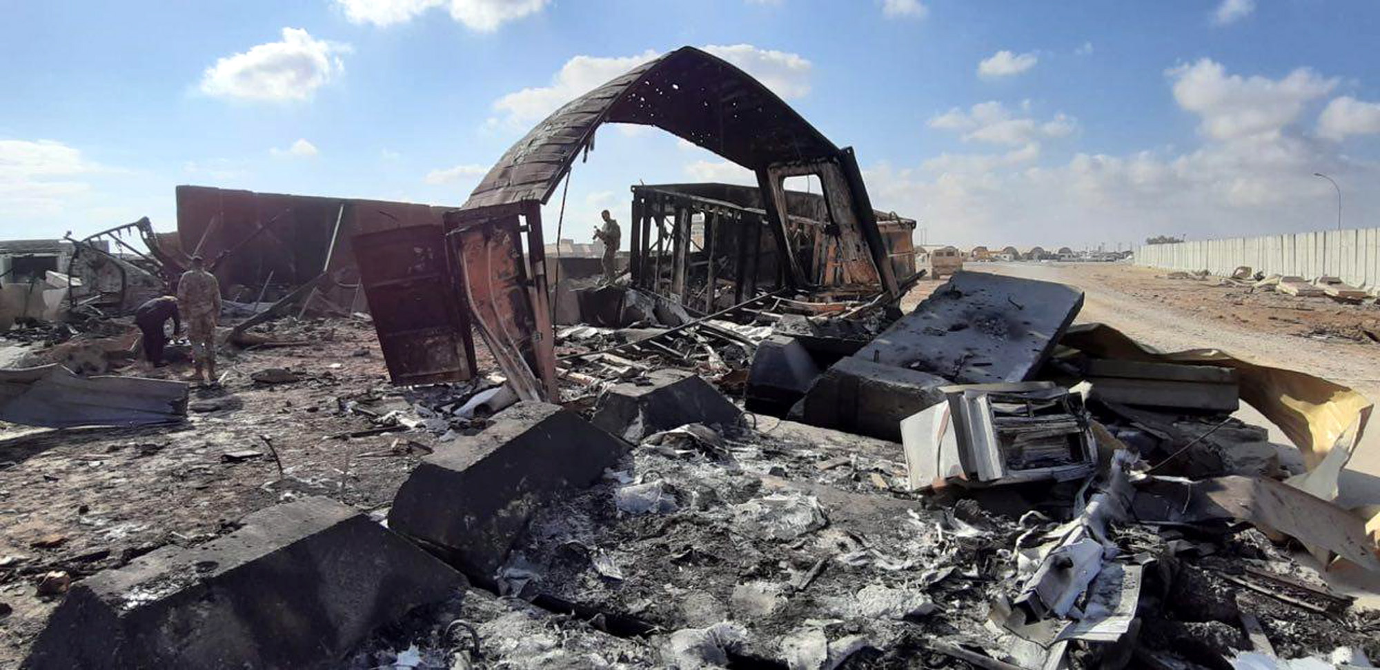 epa08127720 US soldiers stand next the damage that caused by the Iran's missiles attack inside Ain al-Assad air base in Anbar province, Iraq, 14 January 2020. Iran's Revolutionary Guard Crops (IRGC) launched a series of rockets targeting Ain al-Assad air base located in al-Anbar on 08 January 2020, one of the bases hosting US military troops in Iraq. The attack comes days after the Top Iranian General Qasem Soleimani, head of the IRGC's Quds force, was killed by a US drone strike in Baghdad.  EPA/STR