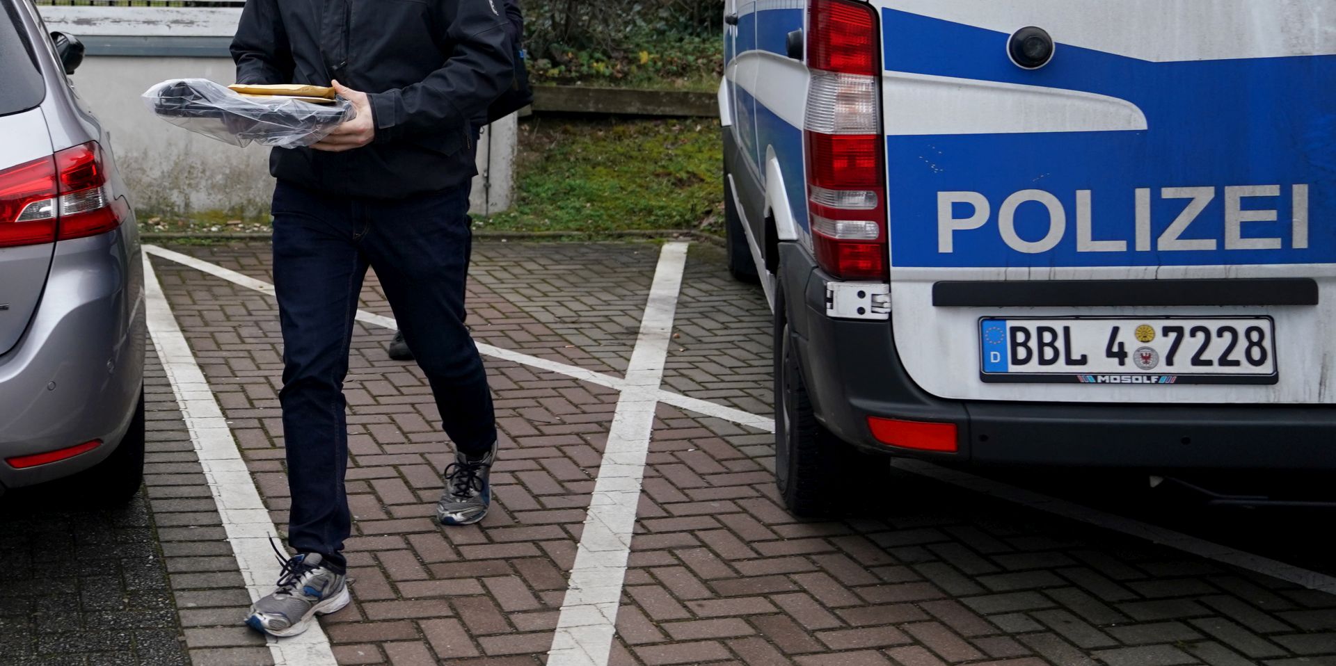 epa08153675 Police officers carry seized evidence during a raid in connection with the militant neo-Nazi group 'Combat 18' near Berlin in Wildau, in the East-German federal state Brandenburg, Germany, 23 January 2020. German Interior Minister Horst Seehofer announced on 23 January 2020 that the 'Combat 18' group has officially been banned by the government.  EPA/ALEXANDER BECHER