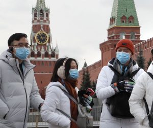 epa08166989 Chinese tourists wearing a medical protection mask walk at the Red Square in Moscow, Russia, 26 January 2020. The outbreak of coronavirus has so far claimed 56 lives and infected more than 2000 others, according to media reports. 
Russian health and immigration officials have taken action to screen those arriving at the country from China over the virus fears.  EPA/MAXIM SHIPENKOV