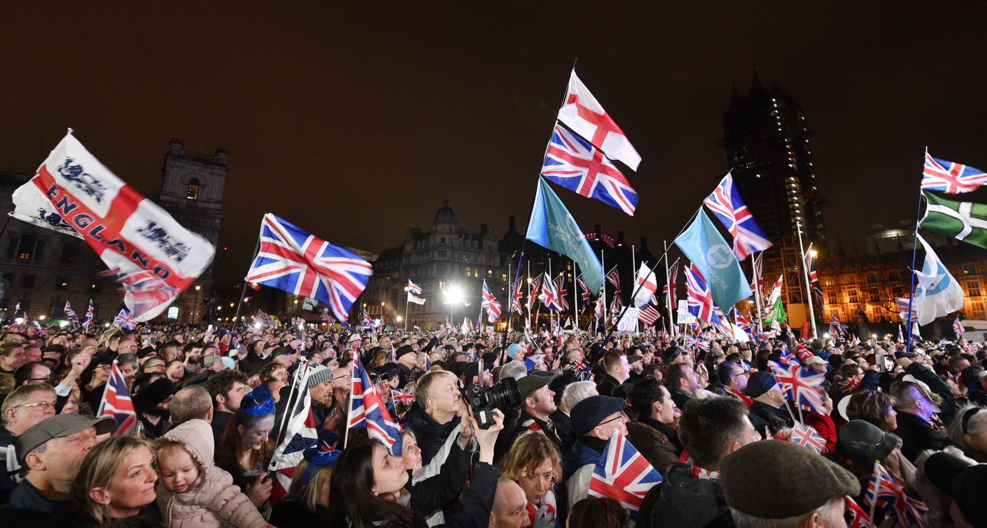 epa08183164 Pro Brexit supporters celebrate outside the Houses of Parliament in London, Britain, 31 January 2020. Britain officially exits the EU on 31 January 2020, beginning an eleven month transition period.  EPA/NEIL HALL