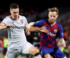 epa08189107 FC Barcelona's Ivan Rakitic (R) duels for the ball with UD Levante's Nikola Vukcevic during the Spanish LaLiga soccer match between FC Barcelona and UD Levante played at the Camp Nou stadium in Barcelona, Spain, 02 February 2020.  EPA/Alberto Estevez