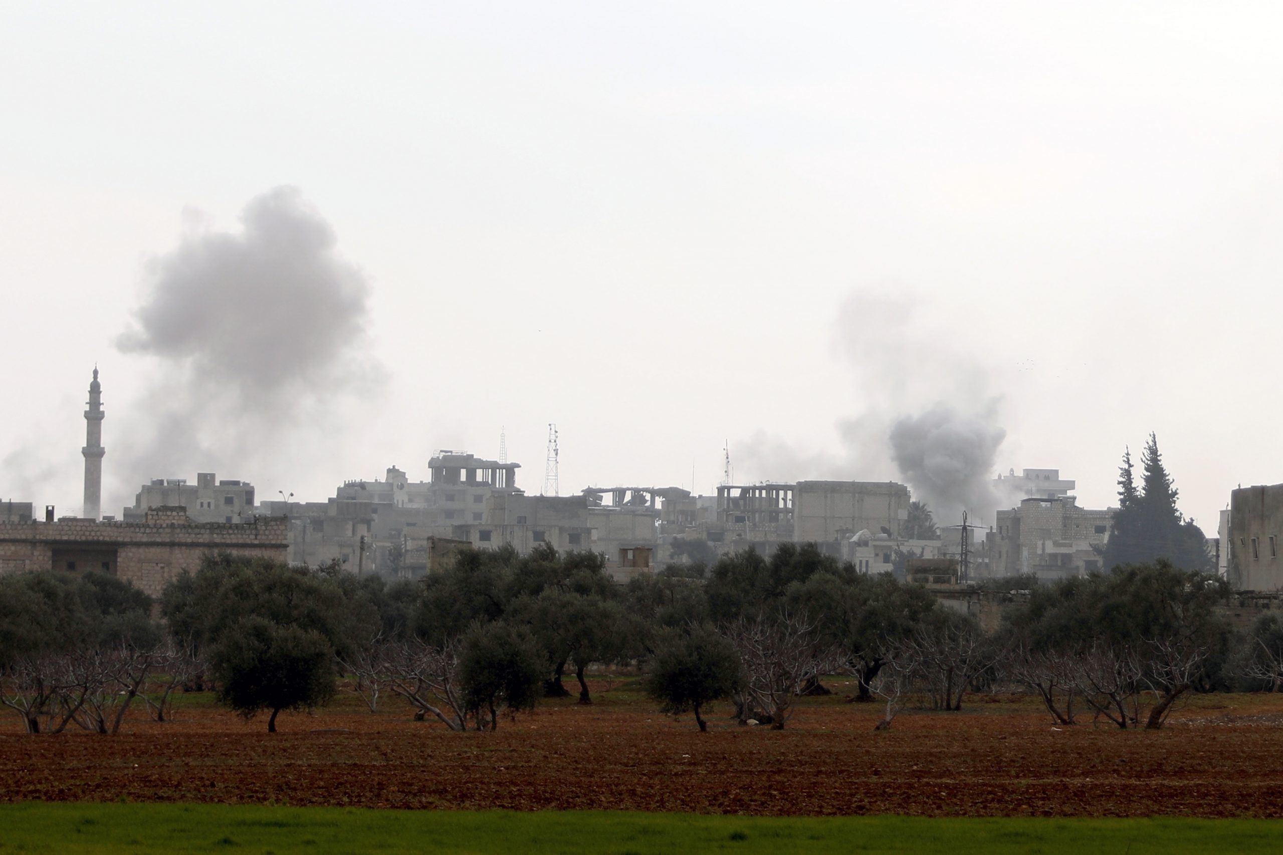 epa08192585 Smoke rises during government forces bombing on the village of Sarman, in Maarrat al-Nu'man district, Idlib, Syria, 04 February 2020. According to Syrian official news reports, the Syrian army units launched operation against last rebel-held stronghold in Idleb and the surrounding areas. According to the UN, 520,000 people were displaced since the operations began in December 2019.  EPA/YAHYA NEMAH