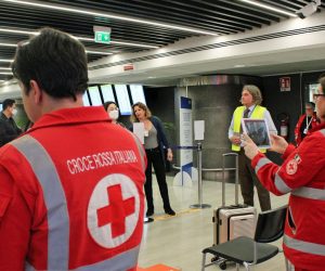 epa08192652 Passengers arriving from domestic, international and Schengen flights are being ushered into corridors ahead of the checks, to allow Red Cross employees to take body temperatures, at Leonardo Da Vinci airport, Rome, Italy, 04 February 2020.  EPA/Telenews
