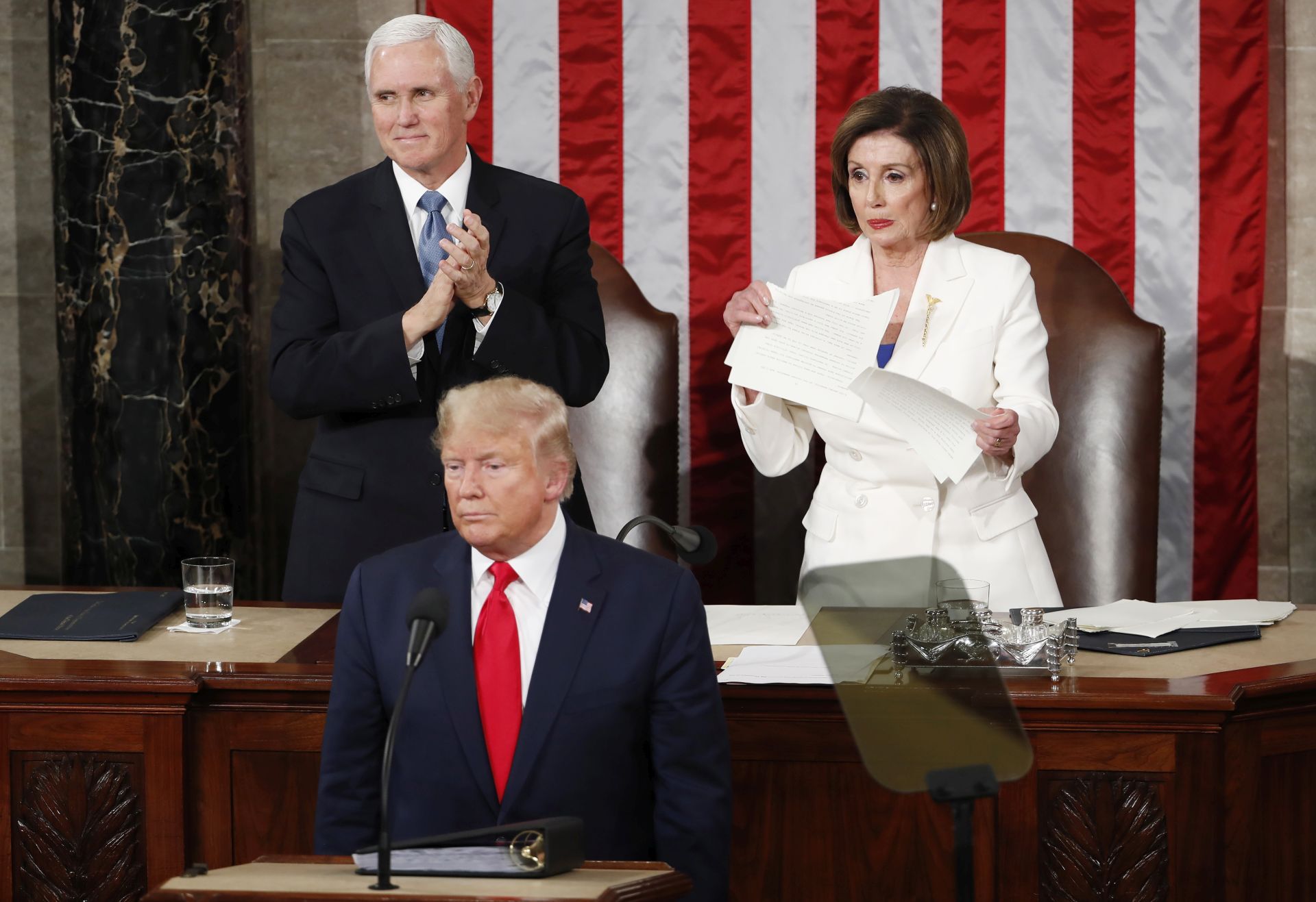 epa08193739 Speaker of the House Nancy Pelosi  (R) tears up a copy of US President Donald J. Trump's State of the Union address as he concludes in front of her and Vice President Mike Pence (L) aduring a joint session of congress in the House chamber of the US Capitol in Washington, DC, USA 04 February 2020. President Trump delivers his address as his impeachment trial is coming to an end with a final vote on the 2 articles of impeachment scheduled for 05 February.  EPA/SHAWN THEW