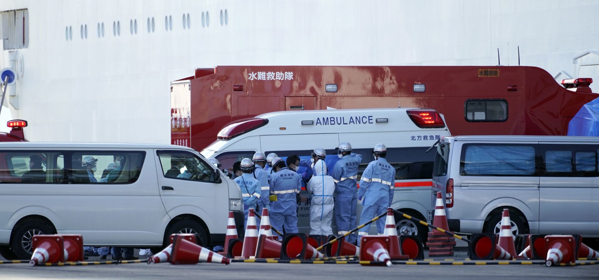 epa08196678 Rescue members gather around an ambulance parked before the Diamond Princess cruise ship at the port of Yokohama in Yokohama, Japan, 06 February 2020. The cruise ship with around 3,700 passengers on board docked in the morning to restock supplies. According to latest media reports, 10 more people have tested positive for the new coronavirus. A total number of 20 people from the ship have been infected by the coronavirus, raising the number of infections to 45 in Japan. According to media reports, around 28,000 people are infected and at least 563 have died from coronavirus.  EPA/FRANCK ROBICHON