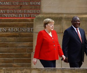 epa08196838 German Chancellor Angela Merkel (L) and South African President Cyril Ramaphosa (R) walk together to inspect honor guards during the official welcoming ceremony at the Union Buildings in Pretoria, South Africa, 06 February 2020. Merkel is on a three-day trip to South Africa and Angola.  EPA/KIM LUDBROOK