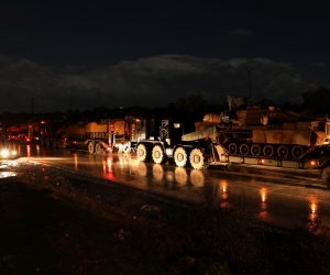 epa08202007 A view of a Turkish army military convoy as it reaches North East Idlib, Syria, late 07 February 2020. According to local media reports, some 150 Turkish army military vehicles of different kinds, which were stationed South and East of Idlib town moved on 07 February evening towards its northern part observation outpost.  EPA/YAHYA NEMAH