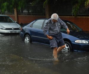 epa08204552 A man leaves his car after it failed to start while sitting in floodwater in Sydney, Australia, 09 February 2020. Accoring to media reports, a powerful storm brough torrential rain to New South Wales, causing flash floods and prompting authorities to issue sever weather warnings for the area.  EPA/JOEL CARRETT AUSTRALIA AND NEW ZEALAND OUT