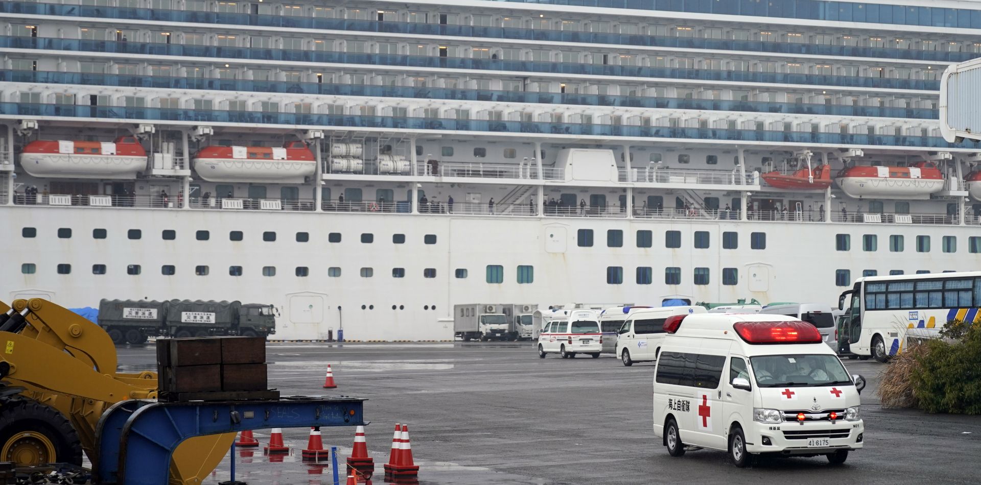 epa08220963 An ambulance believed to be carring an infected passenger of the Diamond Princess cruise ship leaves the Daikoku Pier Cruise Terminal in Yokohama, south of Tokyo, Japan, 16 February 2020. According to latest media reports, another 70 passengers of the Diamond Princess cruise ship have been tested positive for the Covid-19 coronavirus. A total number of 355 people from the ship have been infected by the new coronavirus.  EPA/FRANCK ROBICHON
