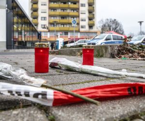 epa08229796 Flowers and candles are placed near a crime scene were five people shoot dead, after two shootings in Hanau, Germany, 20 February 2020. According to media reports, at least nine people were killed in two shootings at shisha bars in the western German city of Hanau, on the outskirts of Frankfurt on 19 February 2020.  EPA/ARMANDO BABANI