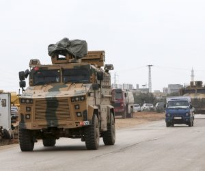 epa08235132 Turkish soldiers and a millitary armored vehicle at the Ad Dana district of north-east Idlib, Syria, 21 February 2020. According to reports, Erdogan said an operation in Syria's Idlib regions was 'imminent'.  EPA/STR