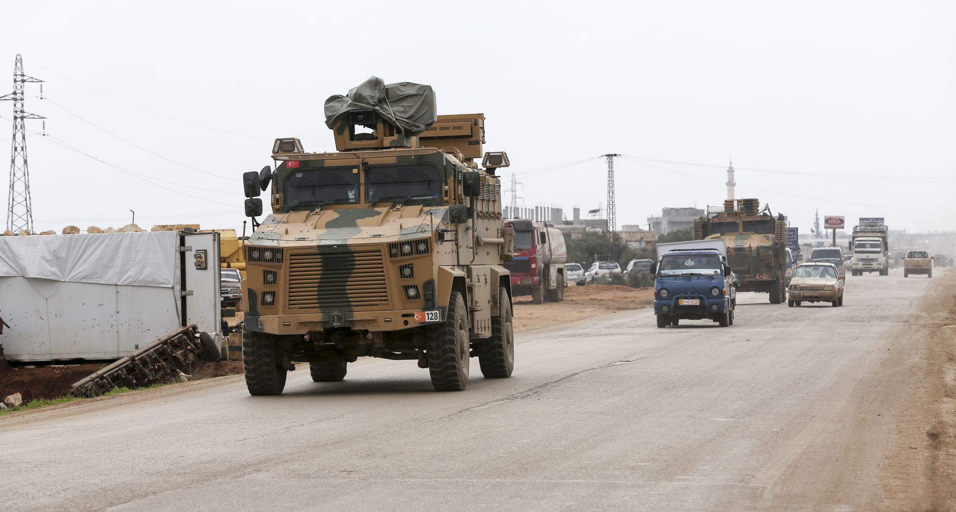 epa08235132 Turkish soldiers and a millitary armored vehicle at the Ad Dana district of north-east Idlib, Syria, 21 February 2020. According to reports, Erdogan said an operation in Syria's Idlib regions was 'imminent'.  EPA/STR