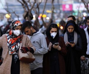 epa08237761 Iranians wearing face masks walk on a street of Tehran, Iran, 22 February 2020. According to the Iranian Ministry of Health, 28 people were diagnosed with coronavirus in the country and five people died of the disease in Iran. The disease caused by the virus (SARS-CoV-2) has been officially named COVID-19 by the World Health Organization (WHO).  EPA/ABEDIN TAHERKENAREH