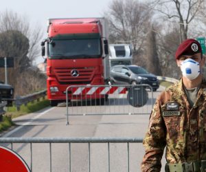 epa08244050 An Italian Army officer wearing a protective face mask stands at a roadblock at the entrance to the small town of Vo' Euganeo, near Padova, northern Italy, 24 February 2020. Italian authorities announced on the day that there are over 200 confirmed cases of COVID-19 disease in the country, with at least five deaths. Precautionary measures and ordinances to tackle the spreading of the deadly virus included the closure of schools, gyms, museums and cinemas in the affected areas in northern Italy.