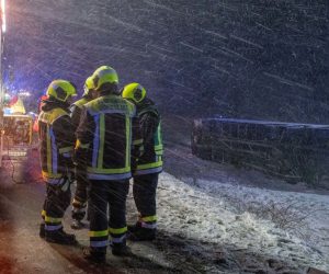 27 February 2020, Baden-Wuerttemberg, Tomerdingen: Firefighters work at the scene where a bus slid over in a field next to the B10 due to snow-smooth road and strong wind, eight people were slightly injured. Photo: Stefan Puchner/dpa