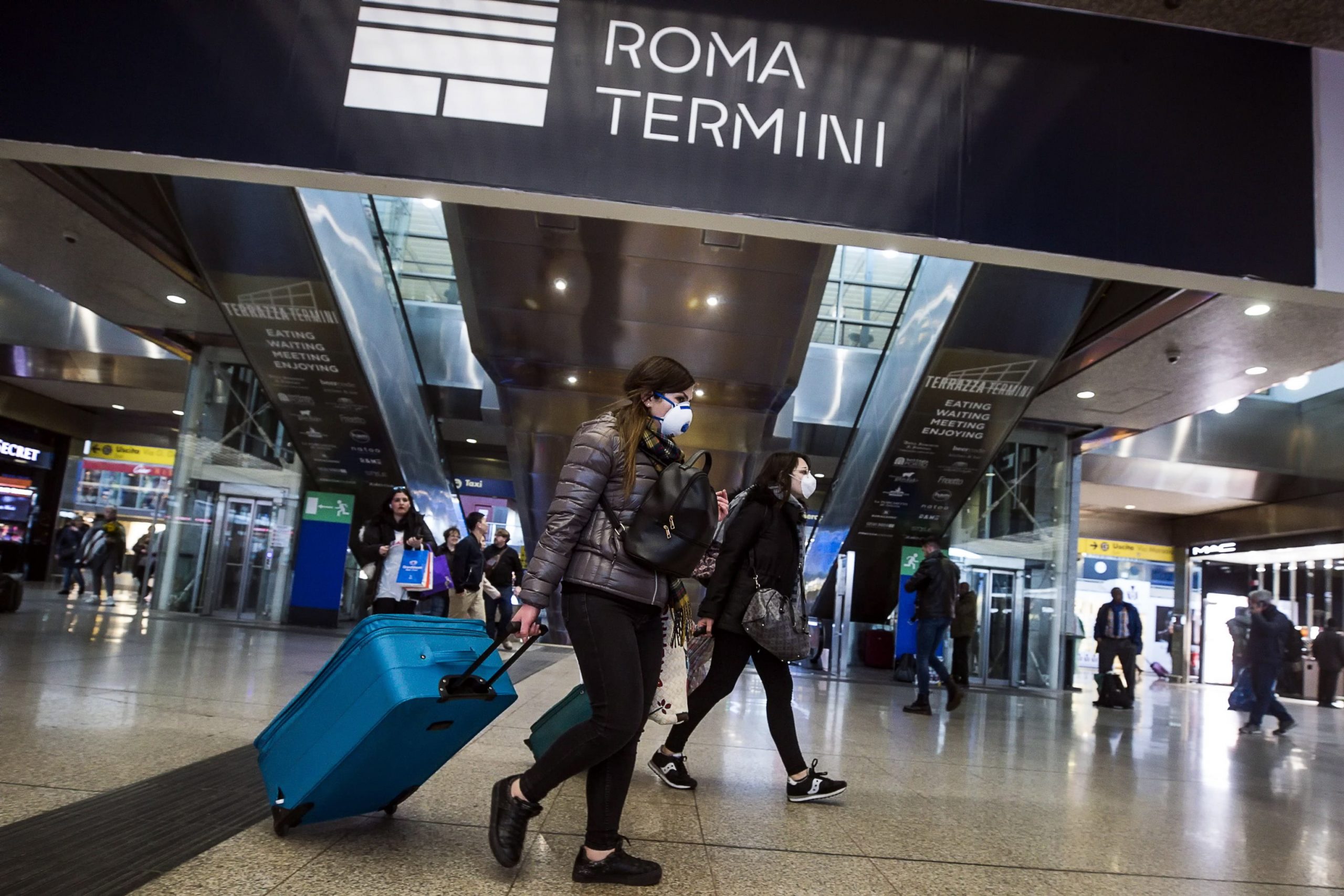 epa08244646 People wearing a protective mask walks at the Termini Station in Rome, Italy, 24 February 2020. Italian authorities announced on the day that there are over 200 confirmed cases of COVID-19 disease in the country, with at least six deaths. Precautionary measures and ordinances to tackle the spreading of the deadly virus included the closure of schools, gyms, museums and cinemas in the affected areas in northern Italy.  EPA/ANGELO CARCONI