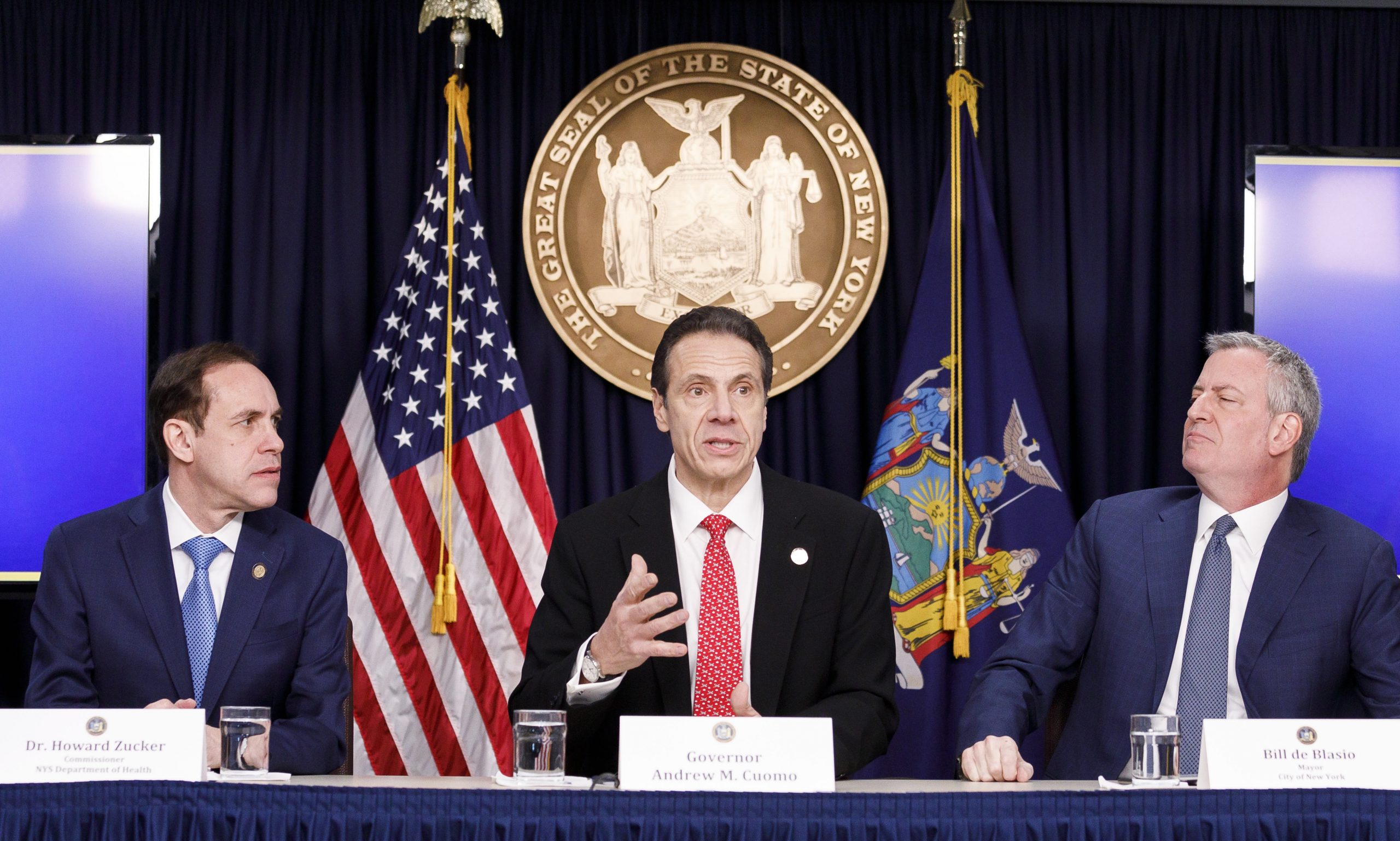 epa08265003 New York Governor Andrew Cuomo (C) speaks as New York City Mayor Bill de Blasio (R) and New York States’ Health Department Commissioner Dr. Howard Zucker (L) listen during a press conference about the city’s first known case of the coronavirus in New York, New York, USA, on 02 March 2020. The patient who tested positive for the virus is a healthcare worker who had recently travelled to Iran.  EPA/JUSTIN LANE