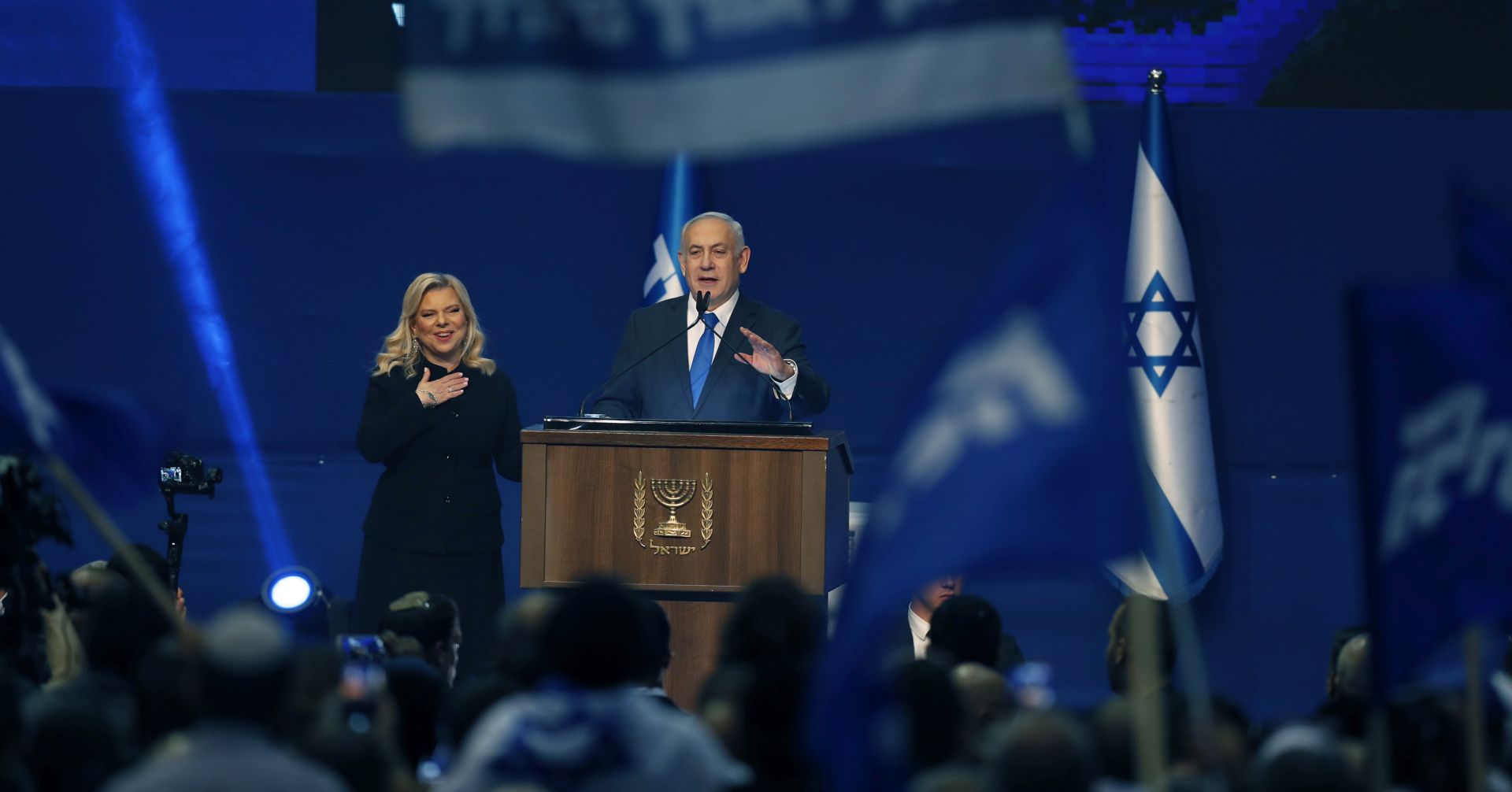epa08265687 Israeli Prime Minister and Chairman of the Likud Party Benjamin Netanyahu (C, right) speaks to supporters at the Likud party final election event after early exit polls, in Tel Aviv, Israel, 03 March 2020. It is the third Israeli parliament election in one year.  EPA/ATEF SAFADI