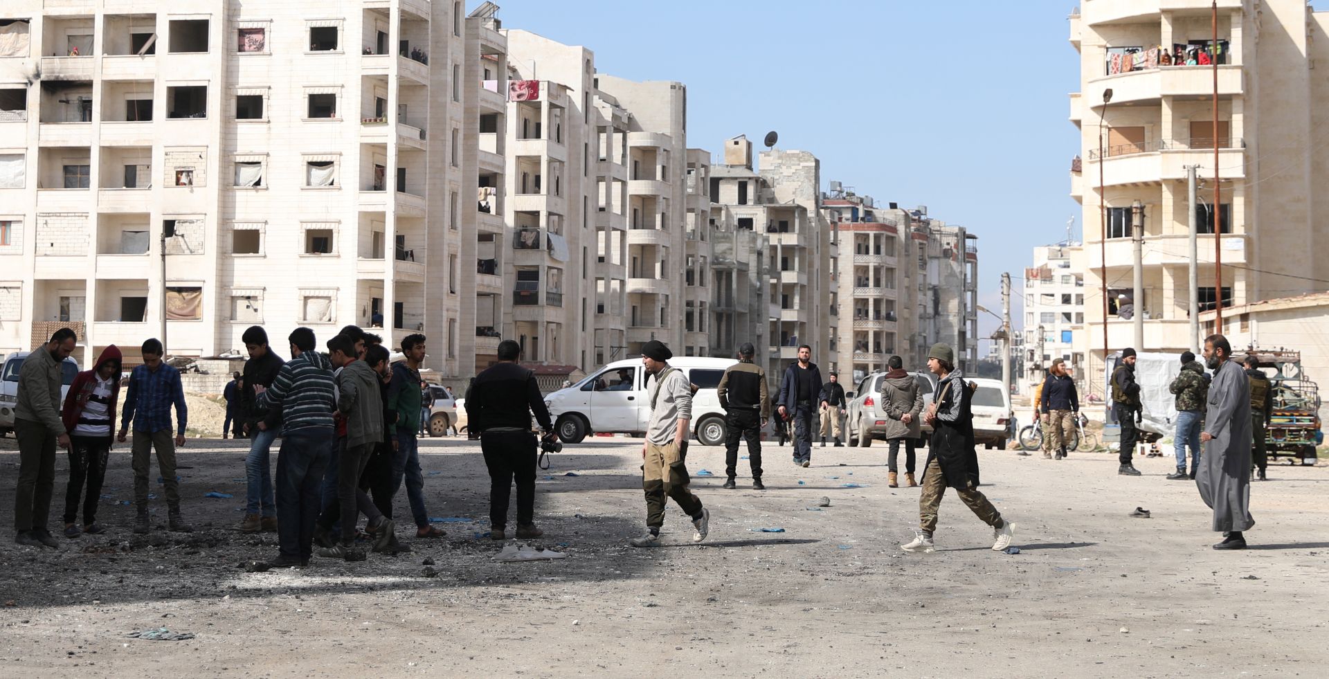 epa08266210 People inspect the site of explosion in Idlib, Syria, 03 March 2020. According to local media sources, at least eight people were killed and 21 were injured in an explosion in Idlib on 03 March, while the exact source of the explosion is not known yet.  EPA/YAHYA NEMAH