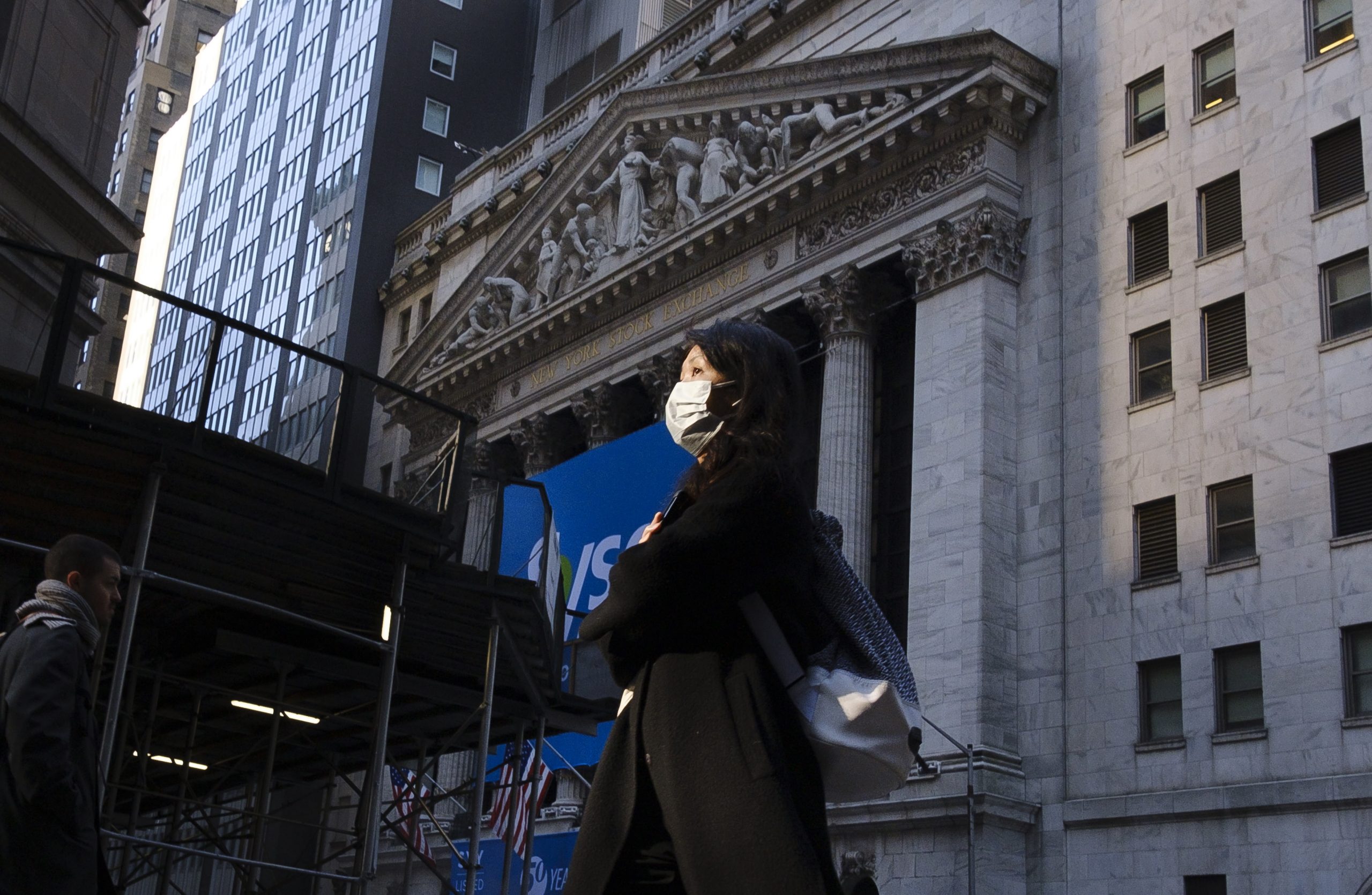 epa08267034 A person wearing a face mask walks past the New York Stock Exchange in New York, New York, USA, 03 March 2020. The previous day, officials announced the city's first known case of the coronavirus in a patient who is a healthcare worker who had recently travelled to Iran, as world financial markets are continuing to react to the spread of the virus.  EPA/JUSTIN LANE
