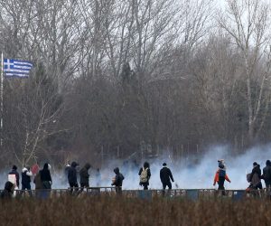 epa08268550 Migrants run from tear gas employed by Greek police officers as they attempt to cross the closed-off Turkish-Greek border in a bid to reach European soil, in Edirne, Turkey, 04 March 2020. Thousands of refugees and migrants are gathering on the Turkish side of the border with Greece with the intention of crossing into the European Union following the Turkish government's decision to loosen controls on migrant flows after the death of 33 Turkish soldiers killed in an attack in Idlib, Syria, on 27 February 2020.  EPA/ERDEM SAHIN