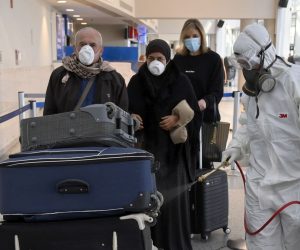 epa08271483 A worker wearing a protective suit sprays disinfectant as a precaution against the spread of the Covid-19 Coronavirus at Rafik Hariri international airport in Beirut, Lebanon, 05 March 2020. According to media reports, two new cases of coronavirus were confirmed on 04 March by a Health Ministry source, bringing the total number of those who have been infected in Lebanon to 15 cases.  EPA/WAEL HAMZEH