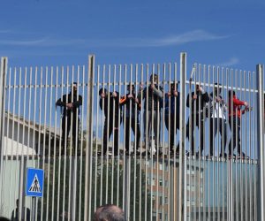 epa08280725 Inmates climb the fence of the detention center during prison riots in Foggia, Apulia region, southern Italy, 09 March 2020. Several inmates in Foggia have reportedly managed to evade after tearing up a gate at the prison's block house and once they reached the road outside where blocked by the police, media reported. Violent protests broke out on the day in 27 Italian prisons against the novel coronavirus restrictions affecting the country with many inmates asking for an amnesty due to the virus emergency. Serious riots are taking place at San Vittore in Milan and Rebibbia in Rome where, as well as burning mattresses, some inmates attacked the infirmaries, media reported.  EPA/FRANCO CAUTILLO