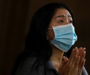 epa08285021 A woman wearing a mask prays inside the Baclaran Church in Paranaque, south of Manila, Philippines, 11 March 2020. Philippine President Rodrigo Duterte on 09 March placed the country under a state of public health emergency amid the coronavirus outbreak. Philippine health officials have confirmed 33 cases of coronavirus so far.  EPA/MARK R. CRISTINO