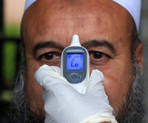 epaselect epa08287925 A Pakistani emergency services worker checks the body temperature of a person during preventive measures against the spread of coronavirus, which causes the disease COVID-19, in Peshawar, Pakistan, 12 March 2020. Pakistani authorities on 11 March confirmed two more ca?ses of coronavirus, bringing the toll to 20 patients as the World Health Organization (WHO) declared the outbreak a pandemic. The disease has spread to 114 countries, killed more than 4,300 people and infected more than 118,000, with the WHO warning these numbers were likely to increase.  EPA/BILAWAL ARBAB