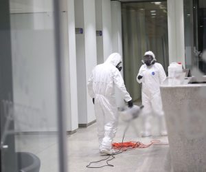 epa08290401 Workers wearing a protective suits spray disinfectant as a precaution against the spread of the Covid-19 Coronavirus at office building in Warsaw, Poland, 12 March 2020. The number of confirmed coronavirus cases in Poland has grown to 51 and a 57-year-old woman in Poznan had become the first person in Poland to die from the COVID-19 disease caused by the SARS-CoV-2 coronavirus.  EPA/Wojciech Olkusnik POLAND OUT