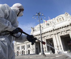 epa08292751 Operators of the Milanese Environmental Services Company (AMSA) wearing white protective overalls, protective masks and glasses sanitize the square of the Central Station using a disinfectant diluted water to avoid further spread of the COVID-19 virus 13 Mach 2020. Tough lockdown measures kicked in throughout Italy on 12 March after Prime Minister Giuseppe Conte announced late on 11 March that all non-essential shops should close as part of the efforts to contain the ongoing pandemic of the COVID-19 disease caused by the SARS-CoV-2 coronavirus.  EPA/Marco Ottico