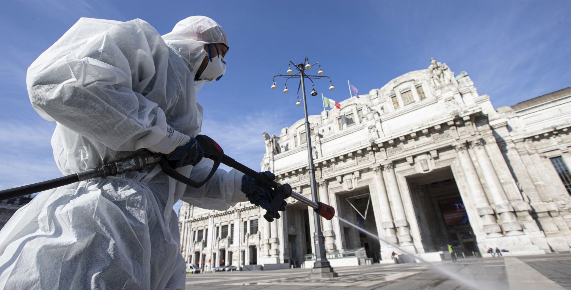 epa08292751 Operators of the Milanese Environmental Services Company (AMSA) wearing white protective overalls, protective masks and glasses sanitize the square of the Central Station using a disinfectant diluted water to avoid further spread of the COVID-19 virus 13 Mach 2020. Tough lockdown measures kicked in throughout Italy on 12 March after Prime Minister Giuseppe Conte announced late on 11 March that all non-essential shops should close as part of the efforts to contain the ongoing pandemic of the COVID-19 disease caused by the SARS-CoV-2 coronavirus.  EPA/Marco Ottico