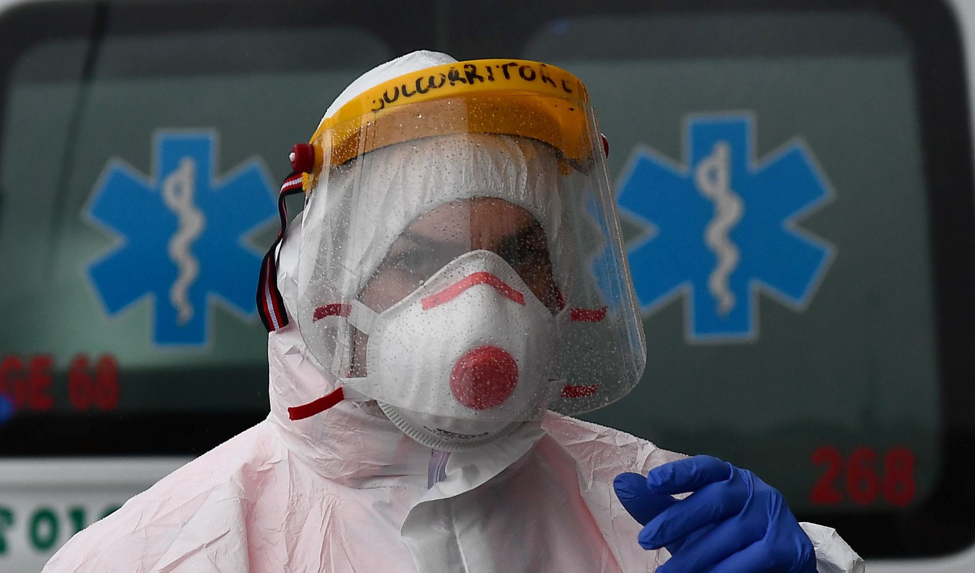 epa08292846 Health workers of the Genoa White Cross wearing protective health masks and overalls get dressed to pick up patients suspected of having contracted the Covid-19 coronavirus, Genoa, Italy, 13 March 2020. Tough lockdown measures kicked in throughout Italy on 12 March after Prime Minister Giuseppe Conte announced late on 11 March that all non-essential shops should close as part of the efforts to contain the ongoing pandemic of the COVID-1.  EPA/LUCA ZENNARO