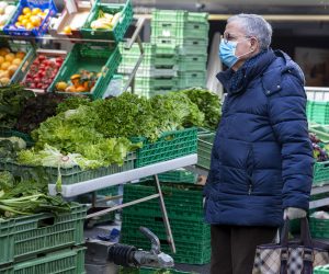 epa08293657 A person wearing protective mask as a precaution against the spread of the novel coronavirus shops for vegetables at the Rive Market, in Geneva, Switzerland, 14 March 2020. Several European countries have closed borders, schools as well as public facilities, and have cancelled most major sports and entertainment events in order to prevent the spread of the SARS-CoV-2 coronavirus causing the Covid-19 disease.  EPA/SALVATORE DI NOLFI