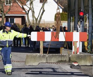 epa08293758 A danish worker is placing a concrete block to close the checkpoint 'Padborg' from Germany to Denmark, near Flensburg, northern Germany, 14 March 2020
The Danish government is closing all Danish borders for Tourists and foreigners traveling without a valid reason, until 13 April due to the coronavirus outbreak. The government announced, that food, medicinis and other important deliveries, as well as cross-border commuters will be able to cross the border.  EPA/MARTIN ZIEMER