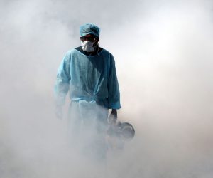 epaselect A Jammu Municipal Corporation health worker sprays disinfectant in a deserted market street after authorities ordered the closure of all shops, except medicines and groceries, to curb the coronavirus pandemic, in Jammu, India, 20 March 2020. All existing Indian visas issued to nationals of any country except those issued to diplomats, officials, UN/International organizations, employment, project visas stand suspended until 15 April 2020. All incoming travelers, including Indian nationals, arriving from or having visited China, Italy, Iran, South Korea, France, Spain and Germany after 15 February 2020 face a 14-day quarantine period.