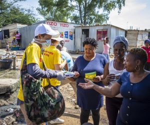 epa08311206 A volunteer from the COVID-19 Action Group hands out information leaflets and soap to residents of the Diepsloot Township in Johannesburg, South Africa, 21 March 2020. This group, working together with Operation SA and Laudium Disaster Management, aims to hand out one million cakes of soap over the next few weeks to help prevent the spread of the COVID-19 disease caused by the SARS-CoV-2 coronavirus in the vulnerable high-density areas of the country's biggest city.  EPA/KIM LUDBROOK