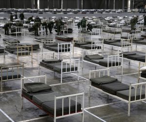 epa08318074 Serbian army soldiers prepare beds for people infected with the coronavirus SARS-CoV-2 at the Belgrade Fair, in Belgrade, Serbia, 24 March 2020. The Serbian authorities declared the state of emergency on 15 March 2020 over the ongoing coronavirus Covid-19 pandemic. Several European countries have closed borders, schools and public facilities, and have cancelled major sports and entertainment events in order to prevent the spread of the coronavirus SARS-CoV-2 which causes the Covid-19 disease.  EPA/ANDREJ CUKIC