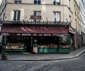 epaselect epa08319659 A man passes by the grocery store 'La Maison Collignon', known for appearing as a movie set in the French film 'Amelie' in Paris, France, 24 March 2020. The shooting of a cinema film taking place in the 1940s in the Montmartre district was interrupted and its sets left in place as France is under lockdown and containment measures in an attempt to stop the widespread of the SARS-CoV-2 coronavirus causing the Covid-19 disease.  EPA/CHRISTOPHE PETIT TESSON