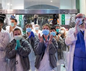 epa08319824 Healthcare personnel react during a collective appreciation clapping event to honor national security forces, healthcare personnel, and society in their fight against coronavirus at Hospital Clinic in Barcelona, Spain, 24 March 2020. Spain is on the tenth consecutive day of a national lockdown imposed by the government to slow down the spread of the pandemic COVID-19 disease caused by the SARS-CoV-2 coronavirus.  EPA/Marta Perez