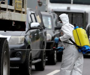 epa08325167 Workers disinfect several vehicles as part of the measures to contain the spread of COVID-19, in one of the entrances to Quito, Ecuador, 26 March 2020. Coronavirus deaths in Ecuador totaled 34, with 1382 cases of inection. President Lenin Moreno ordered a new curfew schedule to apply throughout the country running between two in the afternoon and five in the morning 'except for essential activities'.  EPA/Jose Jacome