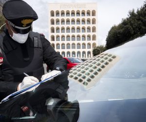 epa08326369 An Italian Carabinieri controls a vehicle at a check point during the nationwide coronavirus lockdown, in Rome, Italy, 27 March 2020. Countries around the world take measures to stem the widespread of the SARS-CoV-2 coronavirus which causes the Covid-19 disease.  EPA/CLAUDIO PERI