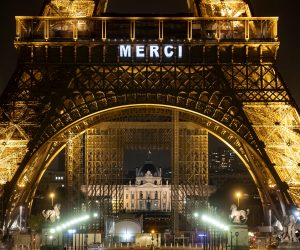 epaselect epa08327564 The word 'Merci' (Thank You) is projected on the Eiffel Tower to honor all personnel contributing to the effort to combat the SARS-CoV-2 coronavirus causing the Covid-19 disease, in Paris, France, 27 March 2020. France is under lockdown in an attempt to stop the widespread of the SARS-CoV-2 coronavirus causing the Covid-19 disease.  EPA/IAN LANGSDON