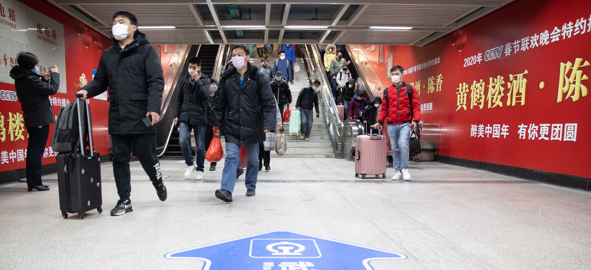 epa08327881 Passengers wearing masks enter a subway station in Wuhan, Hubei Province, China, 28 March 2020. The city of Wuhan, China's epicentre of the coronavirus outbreak, partially resumed rail and subway services on 28 March 2020 after it was locked down for more than two months amid the Covid-19 pandemic.  EPA/YFC CHINA OUT