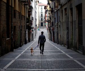 epa08328147 A man walks with his dog on an empty street of Pamplona, Spain, 28 March 2020. Spain faces the 14th consecutive day of national lockdown in an effort to slow down the spread of the pandemic COVID-19 disease caused by the SARS-CoV-2 coronavirus.  EPA/VILLAR LOPEZ
