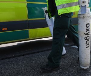 epa08328441 An Ambulance worker unloads Oxygen tanks outside the ExCel Center in London, Britain, 28 March  2020. According to news reports the NHS is anticipating a Coronavirus 'tsunami' as the peak of infarction rates nears. British Prime Minister Boris Johnson has announced that Britons can only leave their homes for essential reasons or may be fined, in order to reduce the spread of the Coronavirus.  EPA/ANDY RAIN