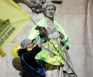 Demonstration against French government's pensions reform plan in Paris A protester stands next to a statue dressed in a yellow vest in front of the Opera Garnier during a demonstration before the opening debate on the French government's pensions reform bill at the National Assembly in Paris, France, February 17, 2020. REUTERS/Charles Platiau CHARLES PLATIAU