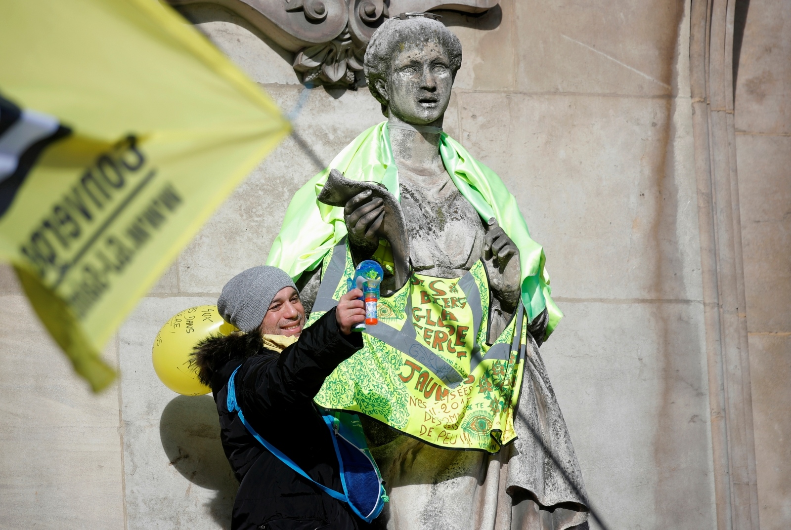 Demonstration against French government's pensions reform plan in Paris A protester stands next to a statue dressed in a yellow vest in front of the Opera Garnier during a demonstration before the opening debate on the French government's pensions reform bill at the National Assembly in Paris, France, February 17, 2020. REUTERS/Charles Platiau CHARLES PLATIAU