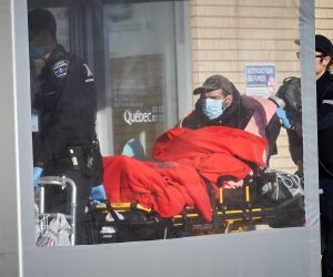 epa08296595 A paramedic brings a patient to Notre-Dame hospital in Montreal, Canada, 15 March 2020. There are more than 39 people with Coronavirus in Quebec after 18 new cases were confirmed on 15 March. The Quebec government announced today the closure of all bars, theatres, gyms, ski hills, sugar shacks, arcades and pools to slow the spread of the pandemic of coronavirus.  EPA/Andre Pichette