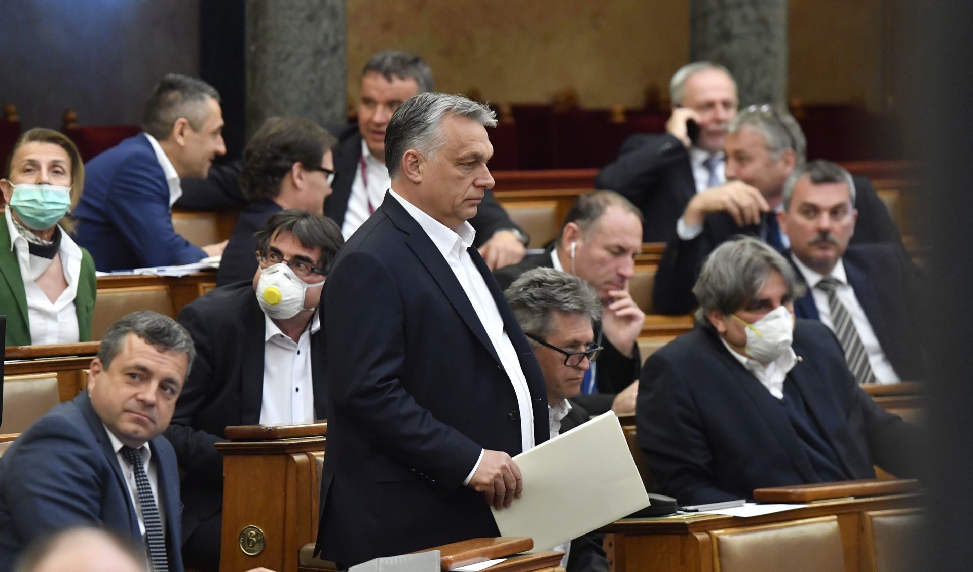 epaselect epa08332120 Hungarian Prime Minister Viktor Orban (C) arrives for the plenary session of the Parliament in Budapest, Hungary, 30 March 2020. Reports state MPs approved legislation that extends a state of emergency and gives the government extraordinary powers due to the ongoing pandemic of the Covid-19 disease caused by the SARS-CoV-2 coronavirus.  EPA/Zoltan Mathe HUNGARY OUT